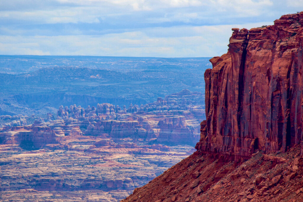 Island in the Sky with the Needles in the distance in Canyonlands National Park, a must visit on a Utah National Parks road trip.